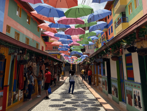 Colourful umbrellas hanging above the street leading to Plazoleta de Los Zócalos