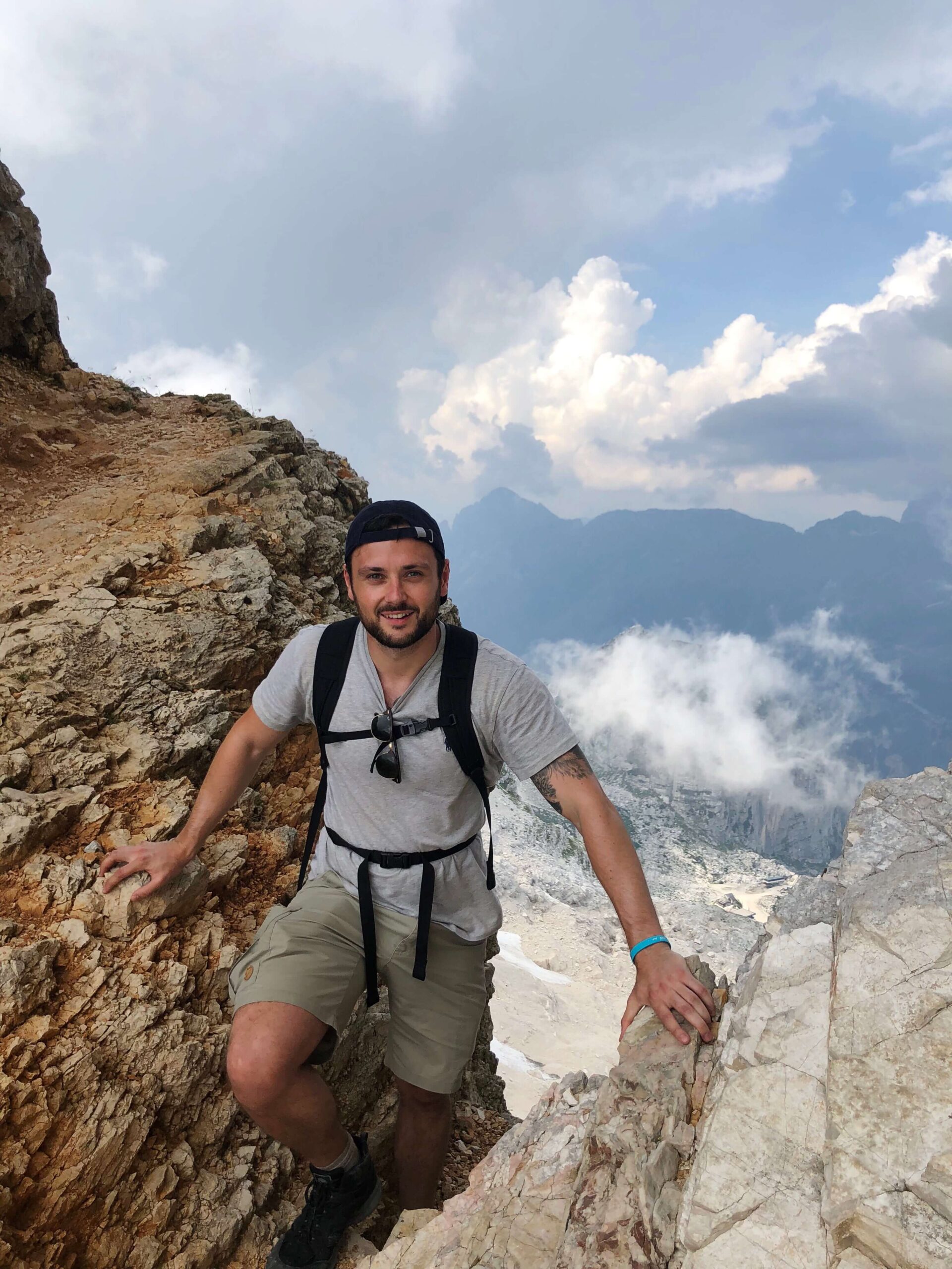 Alex stood in the Prestreljenik Window with the Italian Alps in the background