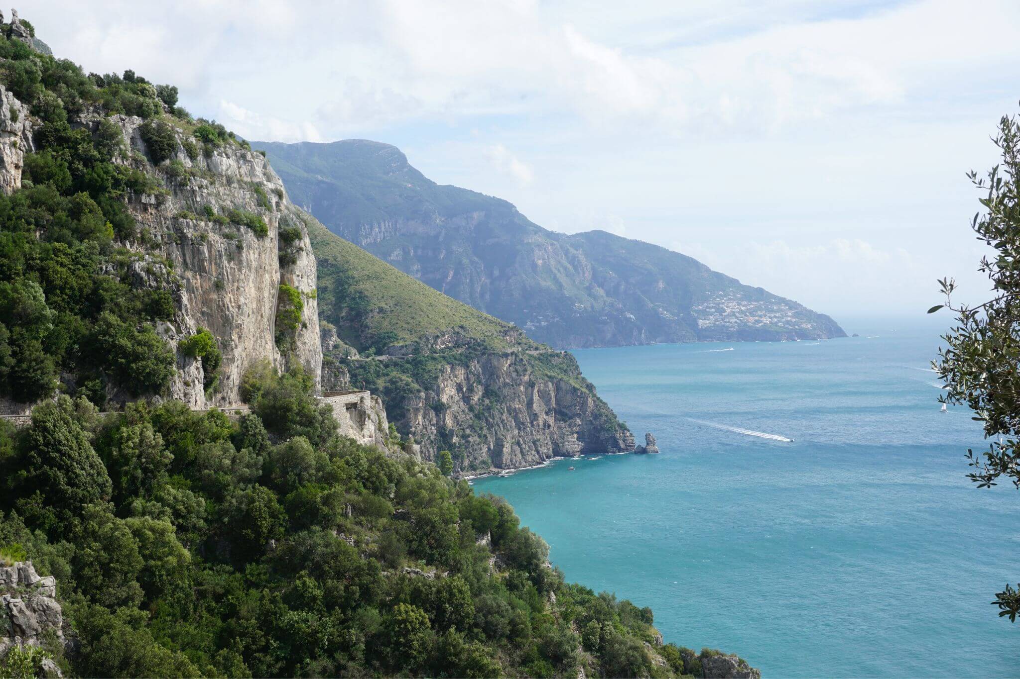 View of the rugged Amalfi Coast Line and the beautiful blue sea at the cliffs.
