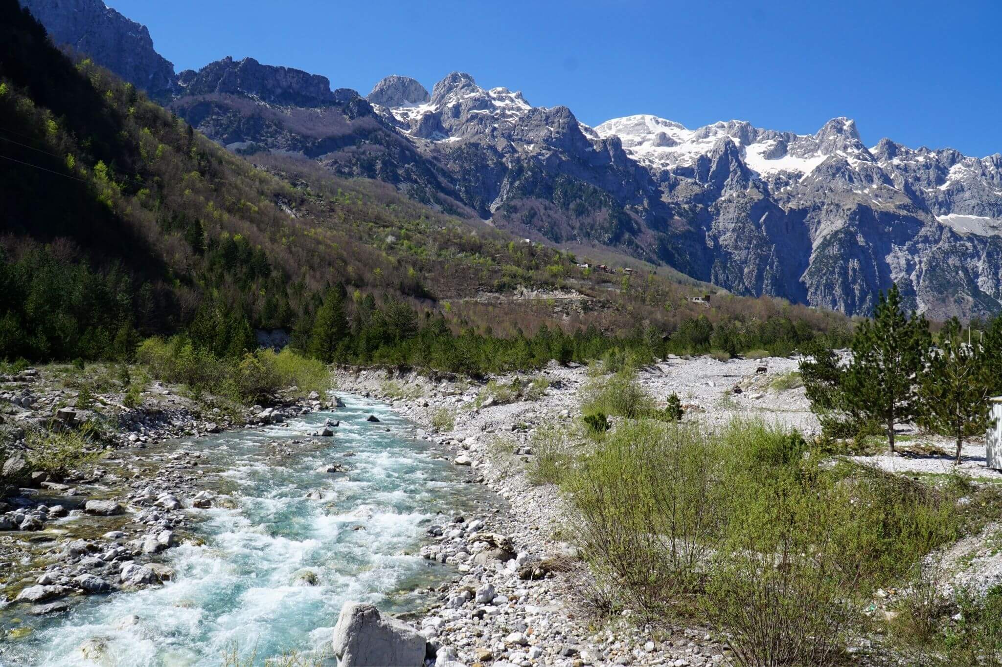 River running through Theth with mountains behind